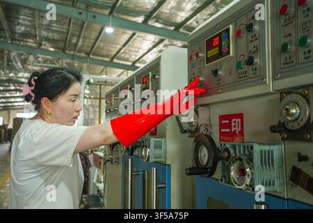 Luanan, China - July 30, 2026: Worker Patrolling Machine Status Between Printing Equipment Stock Photo