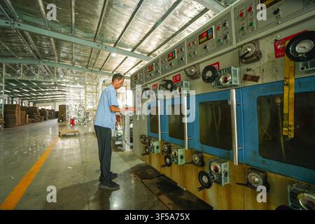 Luanan, China - July 30, 2026: Panoramic View of Workers Operating Printing and Slotting Machine Workshop in Carton Factory Stock Photo