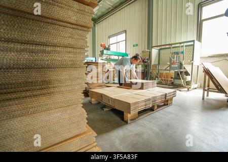 Luanan, China - July 30, 2026: Forklift Worker Transporting Raw Corrugated Paperboards Stock Photo