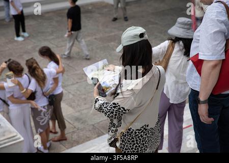 Female tourist reading a travel map, high angle view Stock Photo