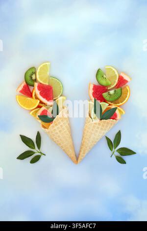 Fun citrus fruit ice cream cornet abstract design. Surreal summer colorful healthy food art theme. Tropical fruits high in antioxidants and Vitamin C Stock Photo