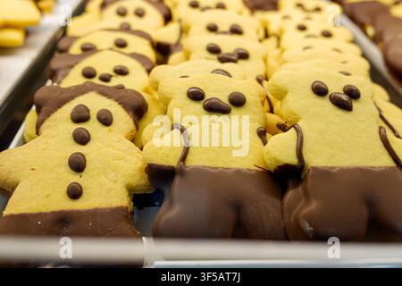 Sweet cookies shaped like gingerbread men and teddy bears dipped in chocolate Stock Photo