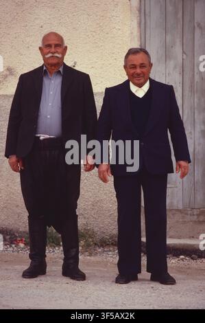 Cyprus. Two mid-age Cypriot men standing together outside old building. Stock Photo