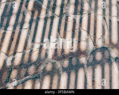 Close-up view of a textured stone surface displaying alternating light and dark stripes, highlighting natural geological patterns and mineral deposits Stock Photo
