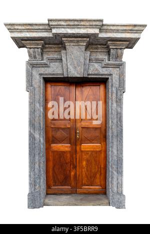 majestic symmetrical shot of a vintage dark wood double door featuring geometric diamond carvings, framed by an ornate grey granite stone portal with Stock Photo