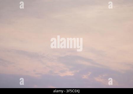 A serene sunset sky filled with gentle pastel pink and purple cloud gradients. High Quality Photo Stock Photo