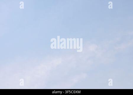 A tranquil light blue sky filled with soft white wispy clouds on a bright clear day. High Quality Photo Stock Photo