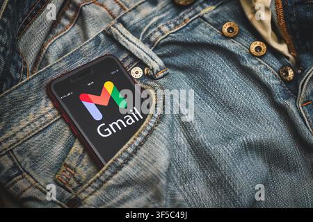 San Pellegrino terme  Italy - July 31 2026:  A smartphone displaying the Gmail app logo is partially placed in the front pocket of a blue denim jeans, Stock Photo