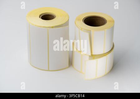 Rolls of white labels isolated. Labels for direct thermal or thermal transfer printing. Blank sticky label roll for thermal transfer printing pirce cr Stock Photo