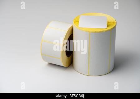 Rolls of white labels isolated. Labels for direct thermal or thermal transfer printing. Blank sticky label roll for thermal transfer printing pirce cr Stock Photo