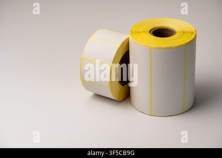Rolls of white labels isolated. Labels for direct thermal or thermal transfer printing. Blank sticky label roll for thermal transfer printing pirce cr Stock Photo