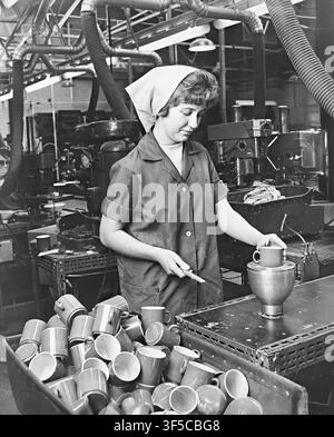 Woman making plastic cups at British Industrial Plastics in Oldbury, West Midlands. 1966 Stock Photo