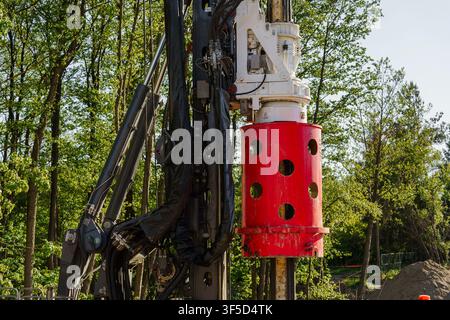 Close up view of a heavy industrial drilling machine operating in a sunny outdoor setting, geotechnical exploration, deep foundation drilling, heavy machinery operations Stock Photo