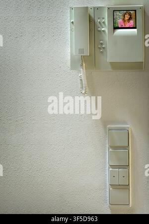 COMMUNICATION CONCEPT: Modern home security intercom unit and electrical switches Stock Photo