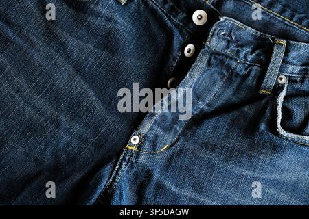 Blue jeans fabric showing texture, stitching, pockets, and button fly detail Stock Photo