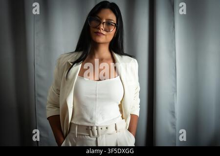 Professional woman wearing glasses standing confidently Stock Photo