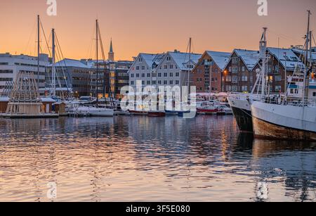 Another fantastic addition to your Tromsø series!  This shot tightens the focus on the Tromsø harbor waterfront with a warmer, golden twilight glow ra Stock Photo