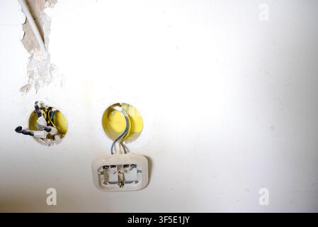 Exposed electrical wires and unfinished wall outlet boxes during residential renovation. Electrical installation in progress before plastering and fin Stock Photo