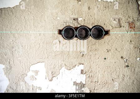 Exposed electrical wires and unfinished wall outlet boxes during residential renovation. Electrical installation in progress before plastering and fin Stock Photo