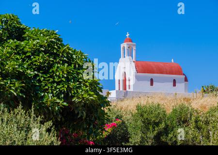 White-walled church with red-tiled roof on hillside in Mykonos, Mykonos, Greece Stock Photo