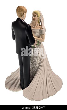 Bride and groom holding hands as they pose for pictures facing the bride Stock Photo