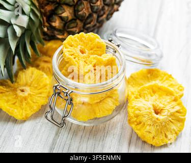 Pineapple dried rings on rustic wooden background Stock Photo