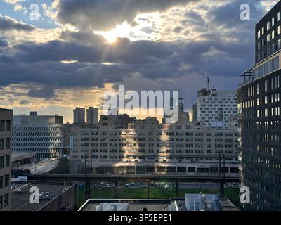 Philadelphia, Pennsylvania, USA- April 15, 2025: Sunlight Breaking Through Clouds Over the City Stock Photo