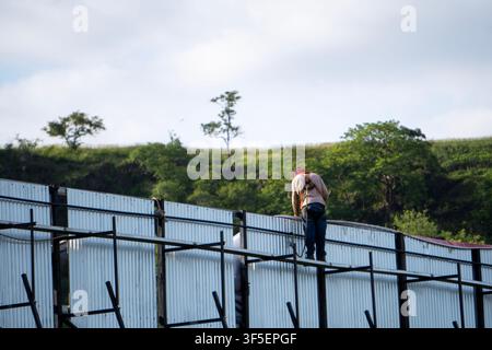 Man working on external billboard structure Stock Photo