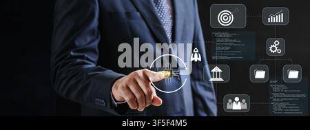 A businessman in a suit interacts with a futuristic digital interface featuring icons for strategy, growth, analytics, and software development, symbo Stock Photo