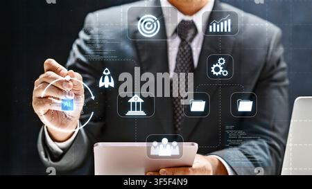 A businessman in a suit interacts with a futuristic digital interface featuring AI, data management, and growth icons to optimize business performance Stock Photo