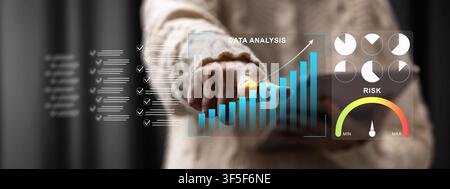 A person interacts with a futuristic digital dashboard showing growth charts, pie graphs, and a risk assessment meter for business performance trackin Stock Photo