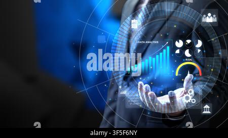 A businessman interacting with a glowing digital hologram displaying bar charts, pie graphs, and risk assessment indicators for advanced data analysis Stock Photo