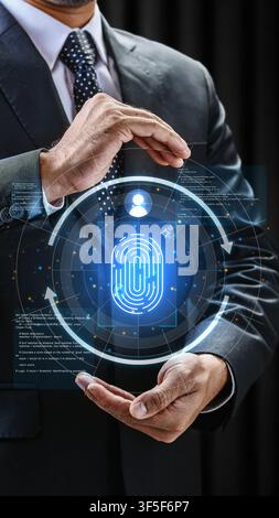 A businessman holds a futuristic digital biometric fingerprint scanner interface, emphasizing cybersecurity, identity protection, and advanced securit Stock Photo