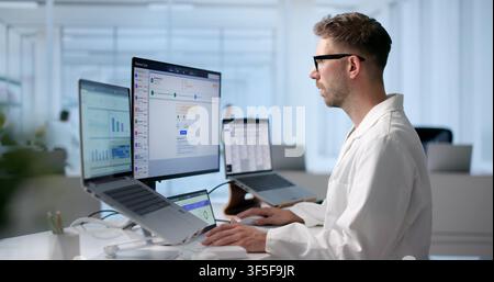 Man Reviews Patient Medical Claims On Laptop To Ensure Billing Accuracy. Stock Photo