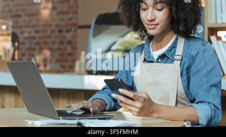 Owner of coffee business works in accounting with social media Stock Photo