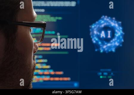 Rear view close up of a programmer watching an AI assistant work on program code on a large monitor. Artificial intelligence chatbots and agent in modern software development. Space for text Stock Photo