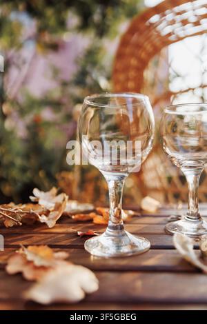 White Wine Glasses on Rustic Autumn Garden Table Stock Photo