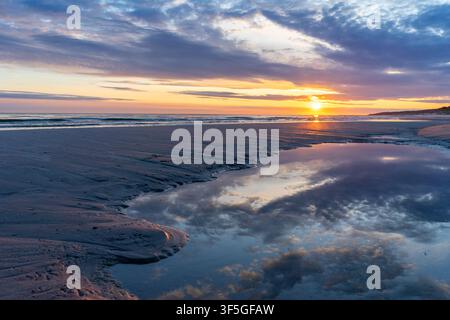 Romantic Sunset Over a Sandy Baltic Sea Beach with Dramatic Clouds – Vacation and Travel Concept Stock Photo