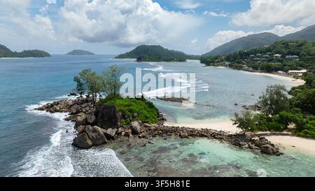 Beach with white sand, crystal-clear waters and tropical foliage. Seychelles, Mahe. Stock Photo