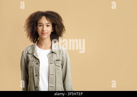 Cute curly african american female in casual, feeling happy and carefree Stock Photo