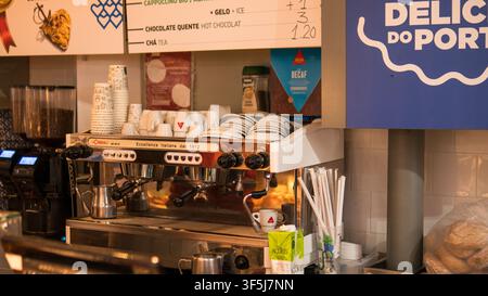 Traditional Espresso Machine with Stacked Cups and Saucers Behind a Café Counter with Portuguese Menu Board in Mercado do Bolhão, Porto Stock Photo