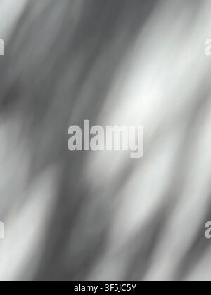 Soft abstract background with blurred gray and white diagonal light streaks, creating a subtle monochrome texture with gentle shadows, highlights, and Stock Photo