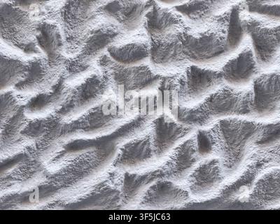 Abstract close-up of uneven white powder with ridges, hollows, and soft shadows, creating a textured monochrome background resembling snowy terrain or Stock Photo
