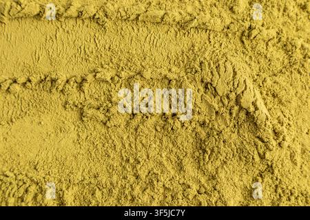 Close-up macro of finely ground matcha green tea powder forming a textured background. Natural organic ingredient concept for beverages, baking, welln Stock Photo