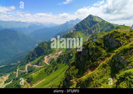 A wide-angle landscape features a winding river flowing through a lush ...