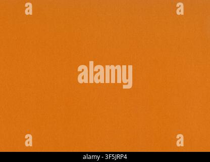 Dark orange surface of thick paper or cardboard, background, texture. Backdrop of paper surface with small pattern. Terracotta, light-brown covering Stock Photo