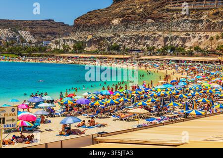 Beautiful view of crowded Amadores Beach with turquoise sea and rocky cliffs on background in Gran Canaria. Gran Canaria. Spain. Stock Photo