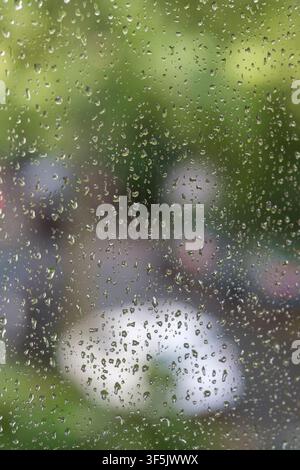 Raindrops on a window pane after a summer rain shower. Stock Photo