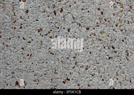 Top view of white outdoor terrazzo paving with natural stone chips, weather resistant architectural surface, realistic material texture. Stock Photo