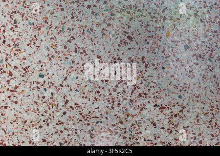 Top view of pink and white terrazzo with small colorful stone chips, showing a clean architectural surface texture suitable for interiors and design. Stock Photo